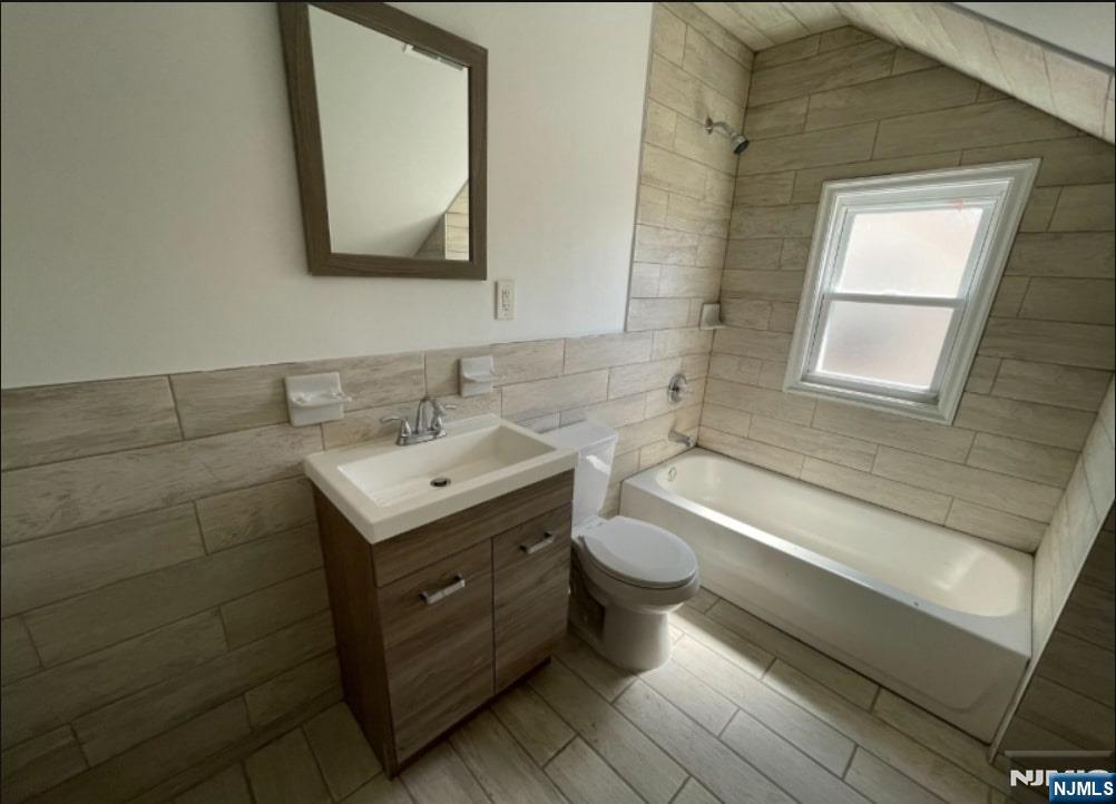 421-423 Leslie Street, Unit 1L Newark, NJ 07112 - Photo 12 of 14 a bathroom with a toilet sink and mirror