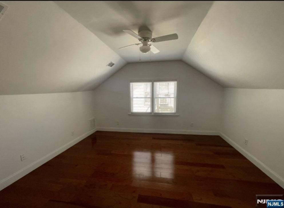 421-423 Leslie Street, Unit 1L Newark, NJ 07112 - Photo 5 of 14 an empty room with wooden floor and windows