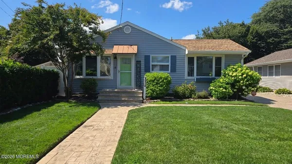 a front view of a house with a yard and porch