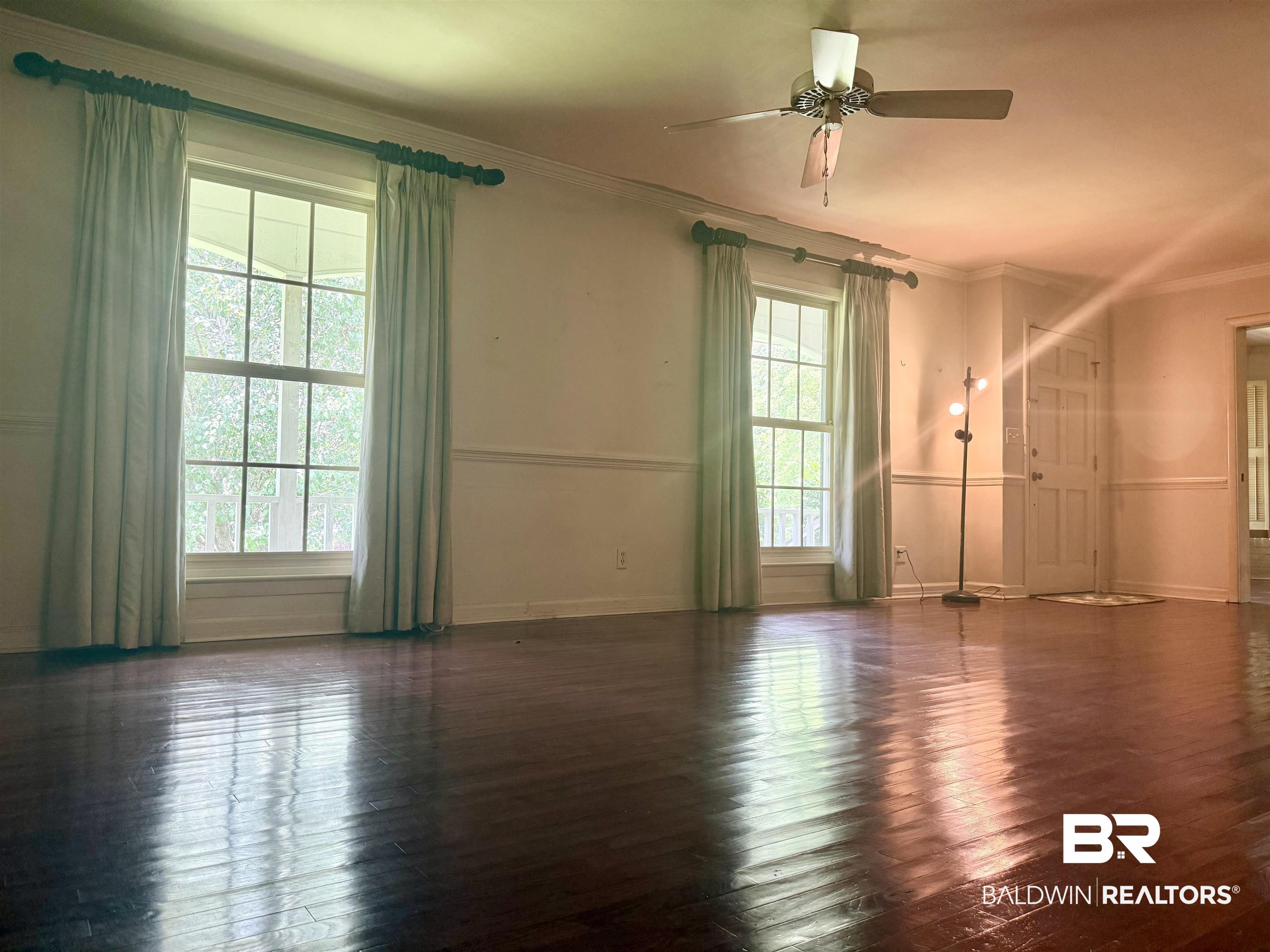1412 Poplar Avenue Brewton, AL 36426 - Photo 4 of 32 Spare room with crown molding, wood-type flooring, a ceiling fan, and baseboards