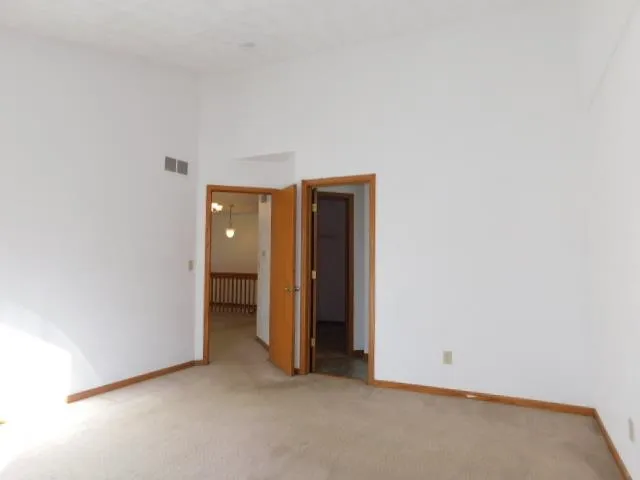 a view of an empty room and closet