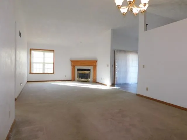 a view of empty room with window and fireplace
