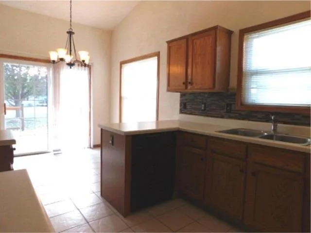 a kitchen with a sink a window and cabinets