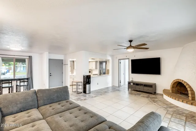 a living room with furniture and kitchen view