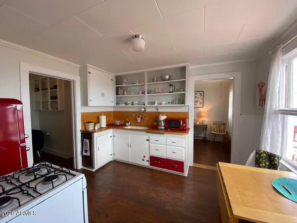 a kitchen with refrigerator and stove