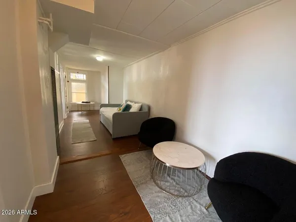 a living room with furniture a rug and a painting