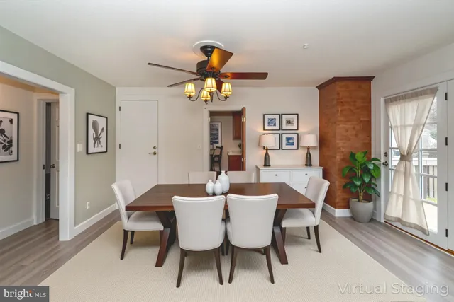 a view of a dining room with furniture and a potted plant