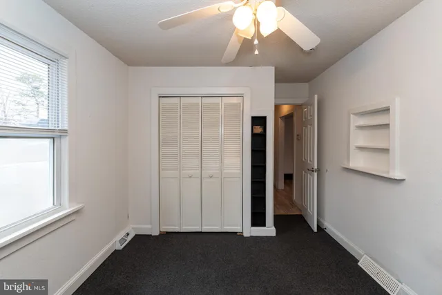 a view of storage and utility room with a hallway