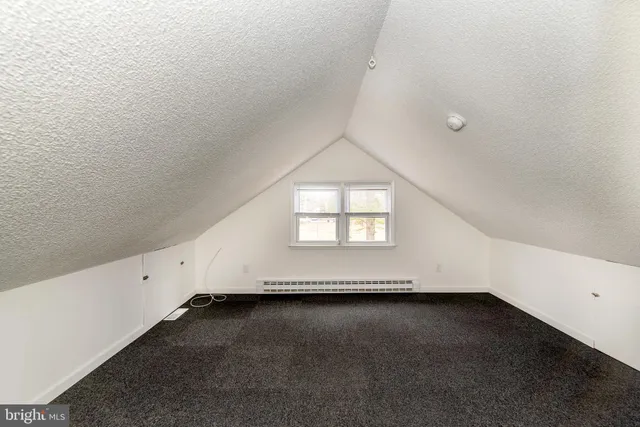 a view of a house with backyard and a tree
