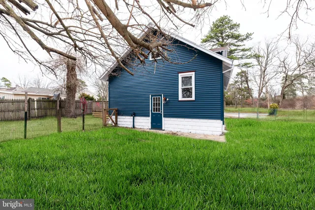 an aerial view of a house with outdoor space and a lake view