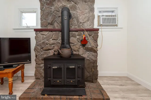a living room with fireplace and a flat screen tv