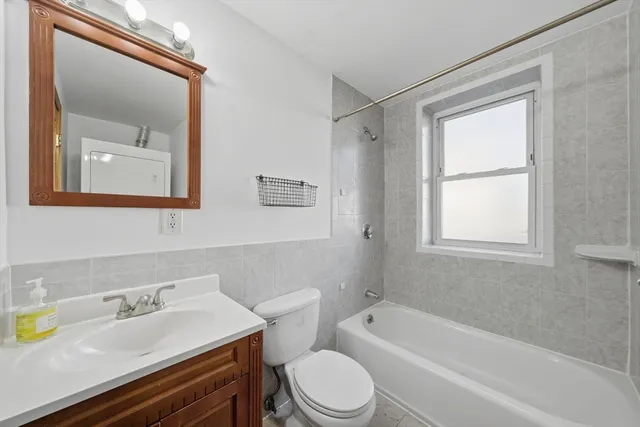 a bath room with a toilet a sink and a bath tub