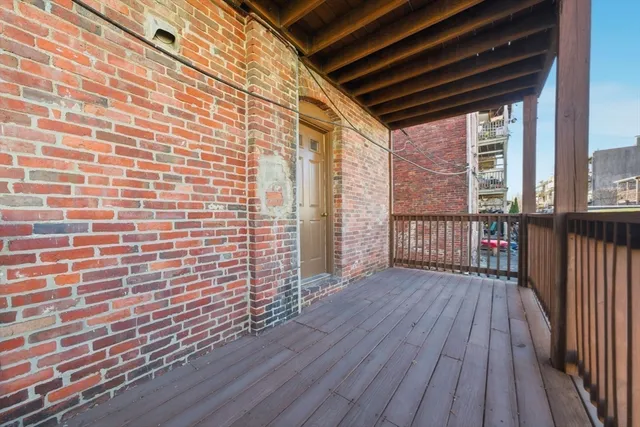 a view of a balcony with wooden floor