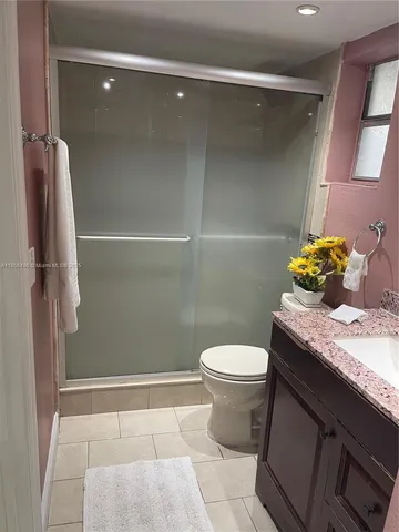 a bathroom with a shower and toilet