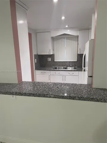 a kitchen with stainless steel appliances granite countertop a sink and a granite counter tops