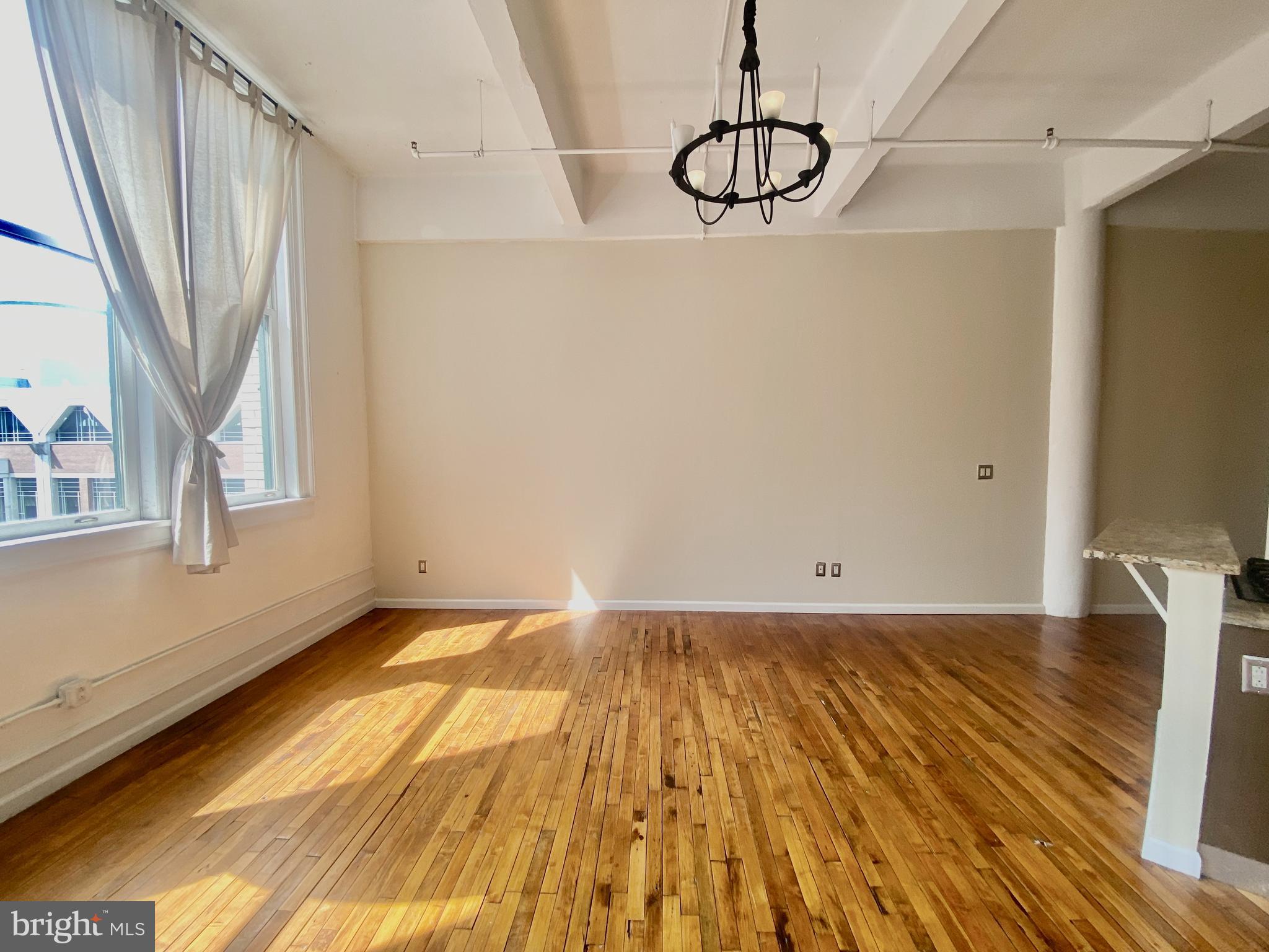 1228-32 Arch Street, Unit 5C Philadelphia, PA 19107 - Photo 20 of 34 a view of a room with wooden floor and brick walls