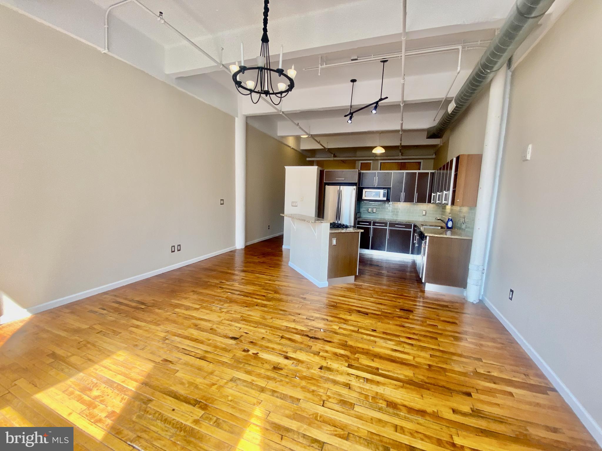 1228-32 Arch Street, Unit 5C Philadelphia, PA 19107 - Photo 21 of 34 a view of a living room with a chandelier