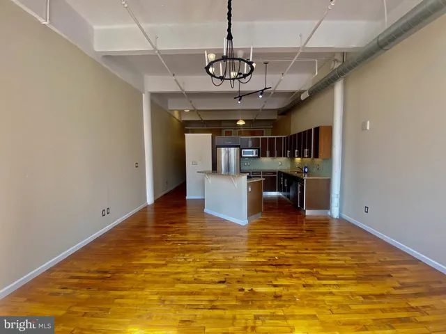 a view of a kitchen with a table and chairs