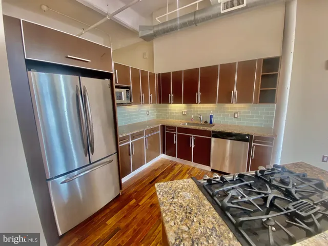a kitchen with a stove and a refrigerator