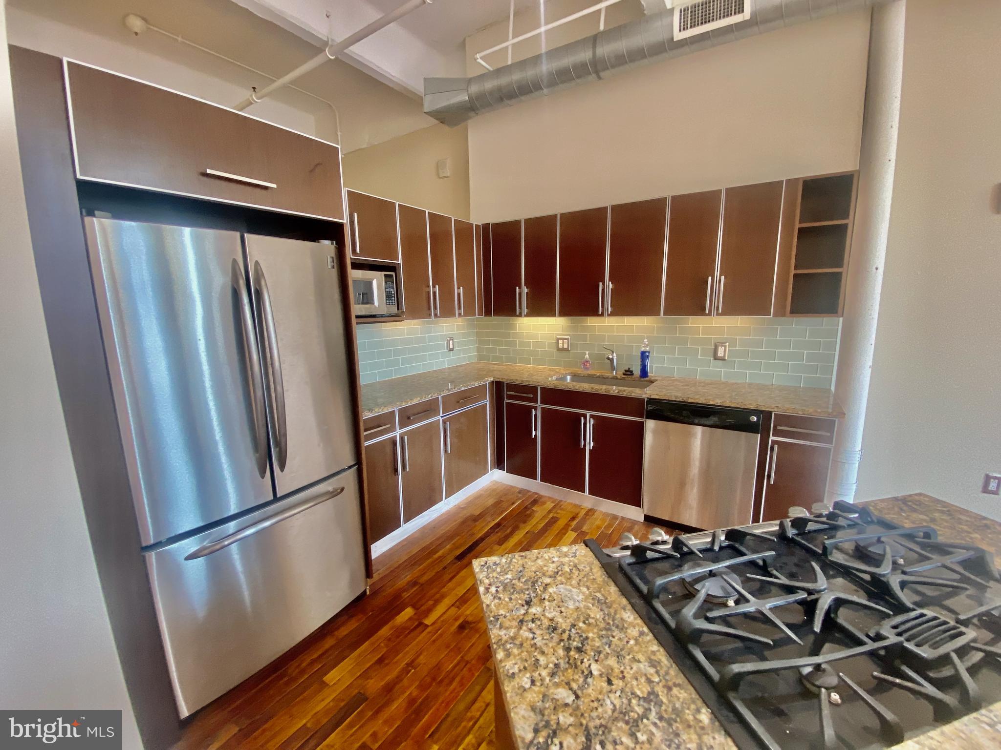 1228-32 Arch Street, Unit 5C Philadelphia, PA 19107 - Photo 28 of 34 a kitchen with a stove and a refrigerator