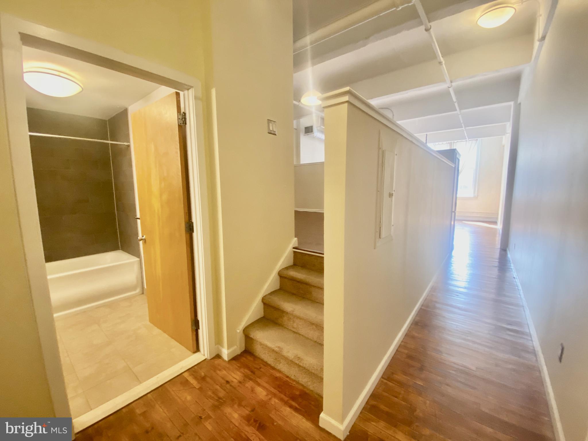 1228-32 Arch Street, Unit 5C Philadelphia, PA 19107 - Photo 5 of 34 a view of a hallway with wooden floor and entryway