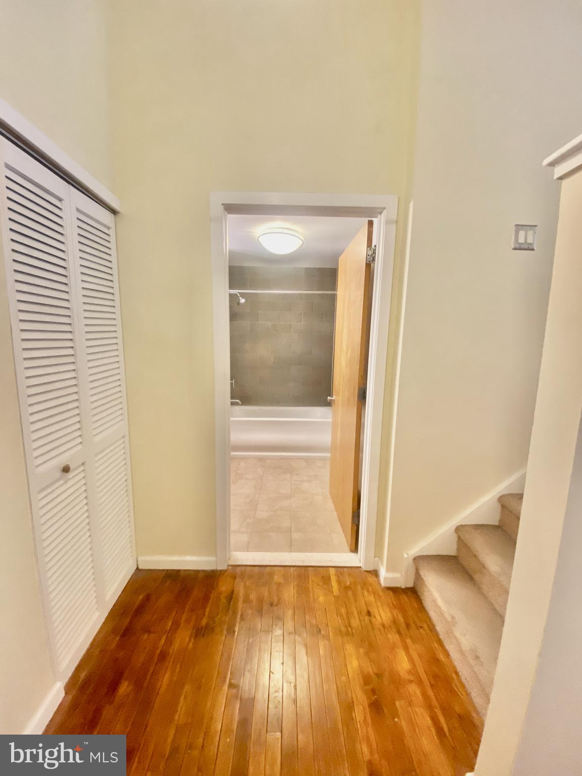 1228-32 Arch Street, Unit 5C Philadelphia, PA 19107 - Photo 6 of 34 a view of an empty room with wooden floor and a window