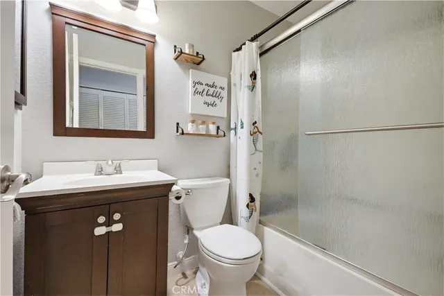 a utility room with washing machine and cabinets