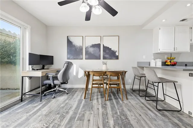 a workspace with wooden floor and a window