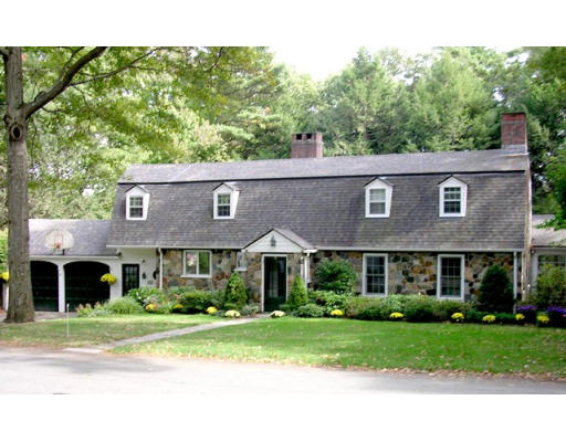 18 Woodridge Road Wellesley, MA 02482 - Photo 1 of 20 a view of a brick house next to a yard with big trees