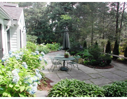 18 Woodridge Road Wellesley, MA 02482 - Photo 19 of 20 a view of a bench in a garden
