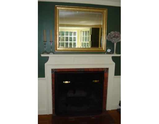 18 Woodridge Road Wellesley, MA 02482 - Photo 6 of 20 a living room with a fireplace and a window