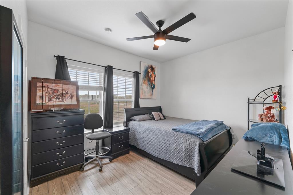 0 Ewing Road Ferris, TX 75125 - Photo 11 of 29 Spacious room featuring wood-finish flooring, white walls, and a ceiling fan with integrated lighting