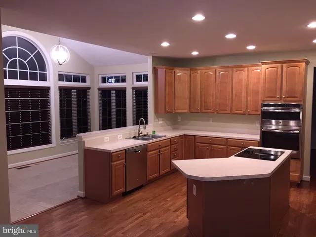 a kitchen that has a sink and a stove in it