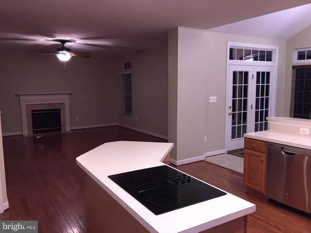 a kitchen with a stove and a bookshelf