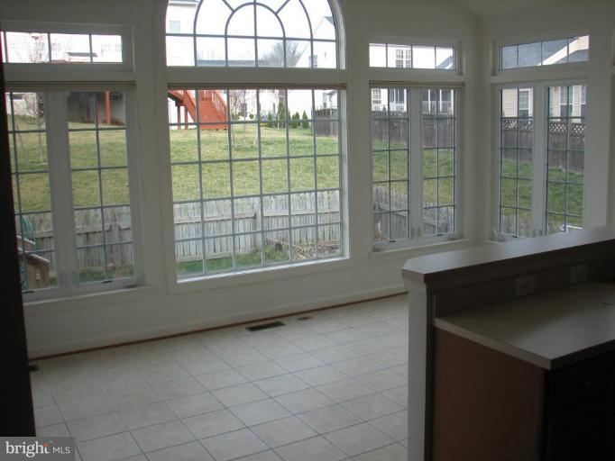 215 Maddex Square Drive Shepherdstown, WV 25443 - Photo 10 of 16 a view of an empty room with a floor to ceiling window and brick walls
