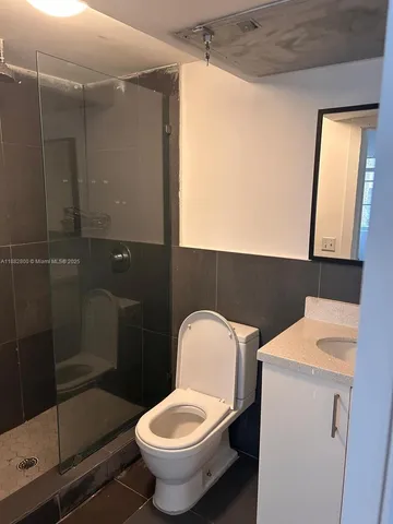 a bathroom with a toilet and a shower