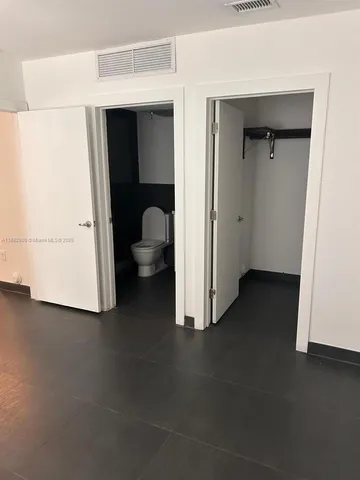 a view of a room that has a bed in it