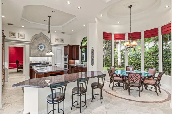 a bathroom with a granite countertop sink a toilet and a mirror
