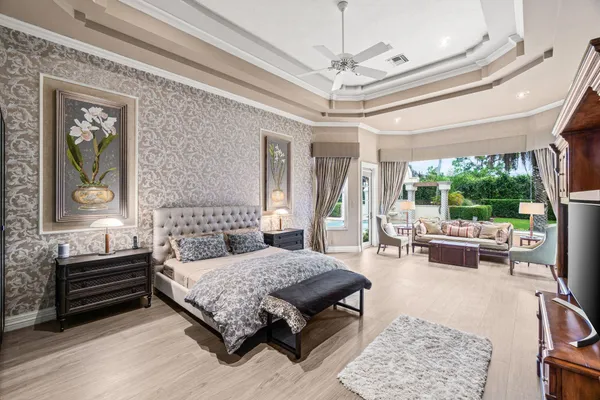 a bedroom with a bed mirror and a window