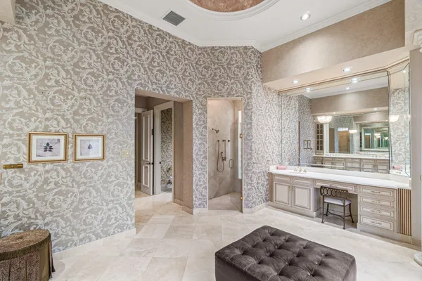 a front view of a house with a yard and potted plants