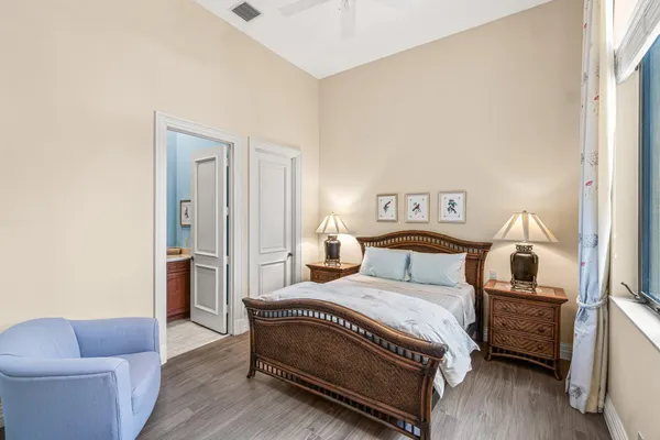 a view of a hallway with entryway wooden floor and couches