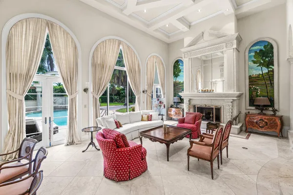 a living room with furniture a fireplace and a large window