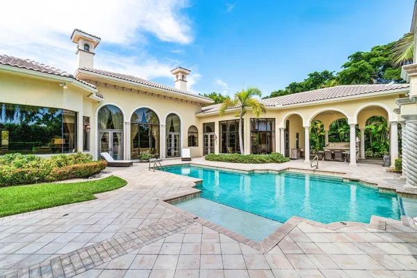 a view of a swimming pool with outdoor seating