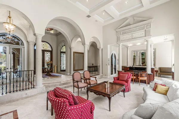 a kitchen with kitchen island granite countertop a stove oven and a sink with wooden cabinets