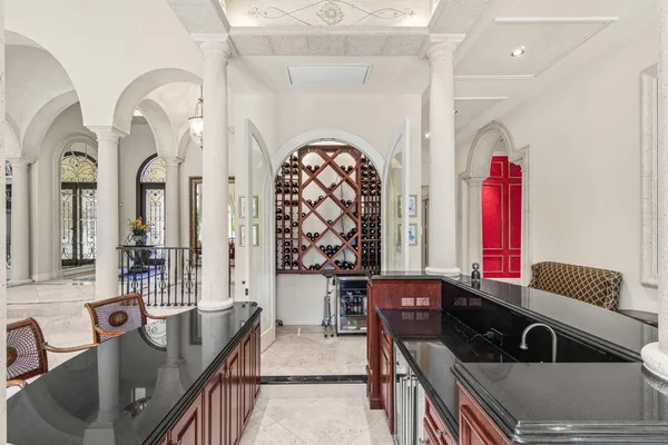 a kitchen with stainless steel appliances kitchen island granite countertop a dining table chairs and granite counter tops