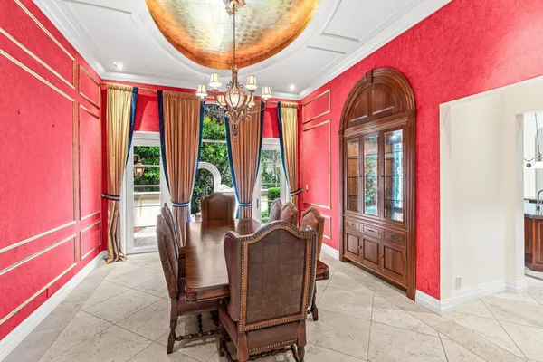 a view of a dining room and livingroom with furniture wooden floor a chandelier