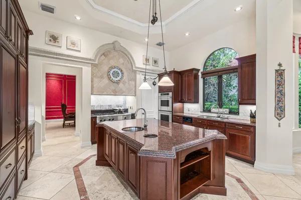 a dining room with furniture a chandelier and wooden floor