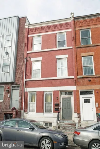 a front view of a building with parking space