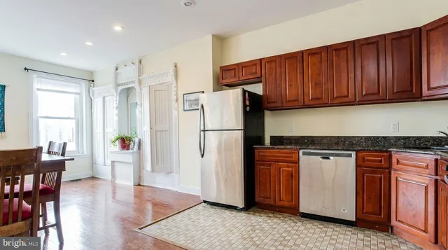 a kitchen with stainless steel appliances granite countertop a refrigerator sink and cabinets