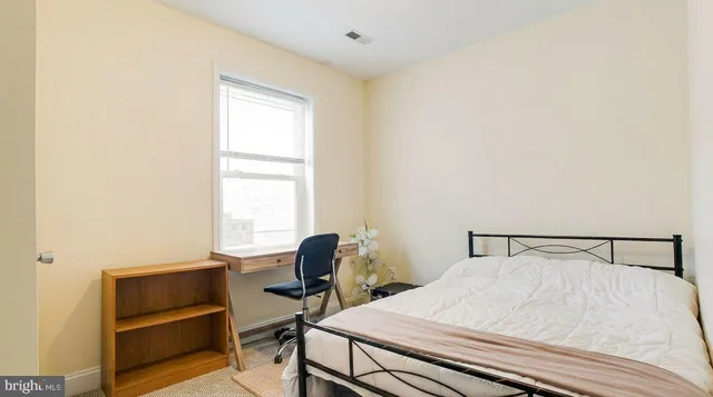 a bedroom with a bed and a window